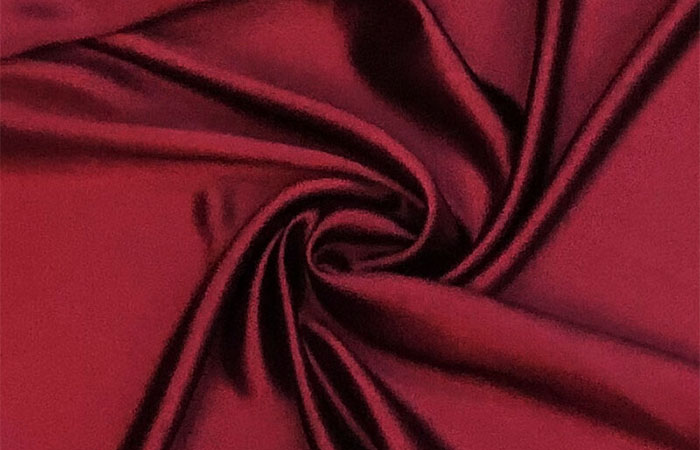 Burgundy dyed acetate fabric