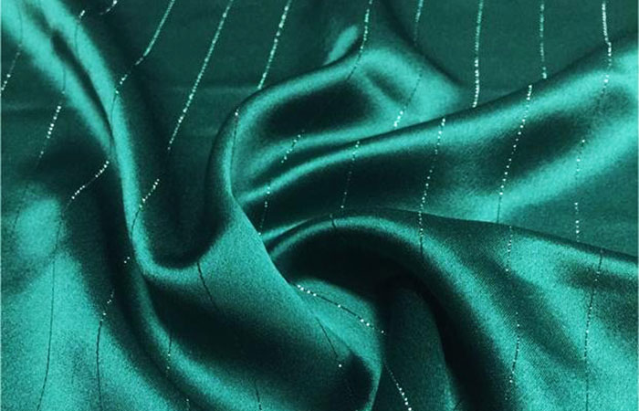 Dark green acetate fabric with stripe of metal