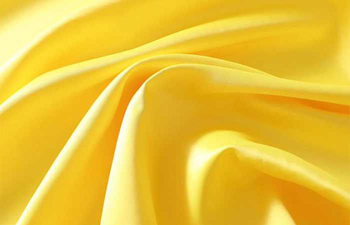 Yellow dyed acetate satin fabric